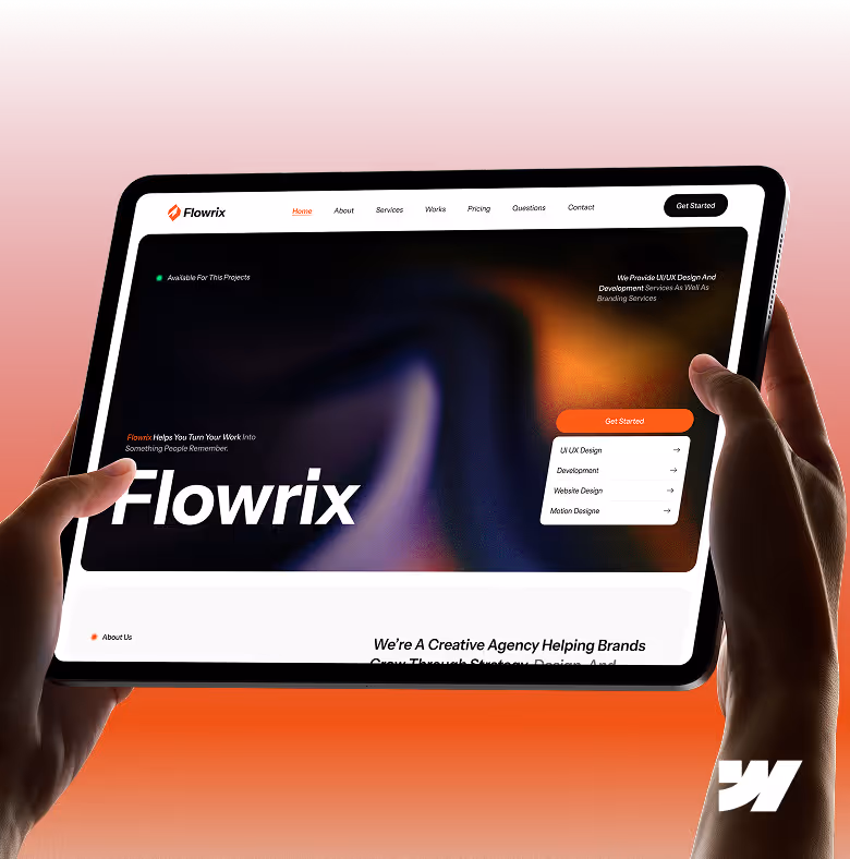 Two hands holding a tablet displaying Flowrix creative agency website with orange gradient background.