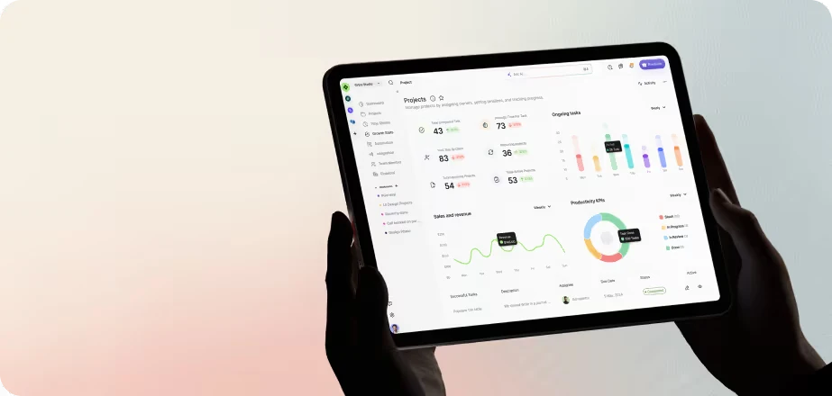 Person holding tablet displaying graphs, charts, and performance metrics on a light background.